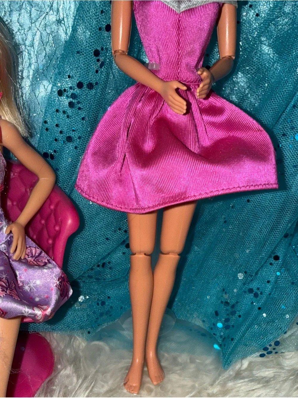 2 Barbie dolls in dresses 1 vintage 1 new chair not included